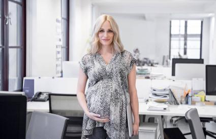 Pregnant businesswoman smiling