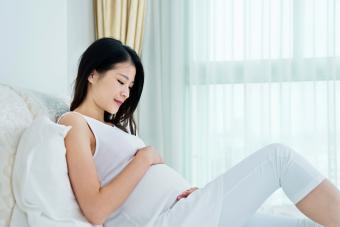 Pregnant woman sitting in bed