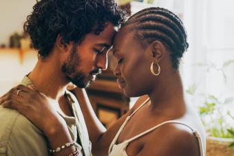 couple standing together and sharing an intimate moment at home