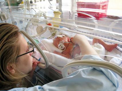 Mother with baby in incubator