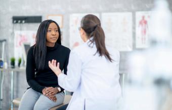 Young woman speaking with a doctor