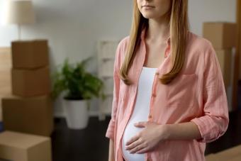Young pregnant woman in new apartment
