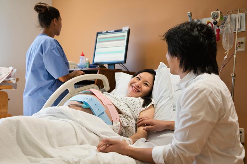 Ready pregnant woman in hospital bed