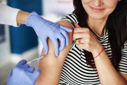 Woman receiving an injection in her arm