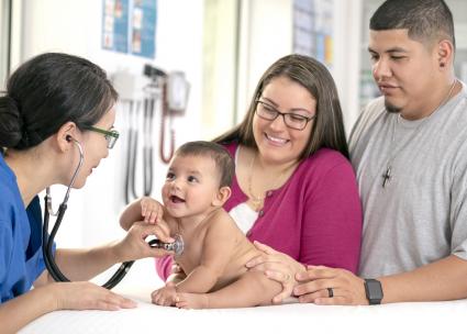 Baby getting check-up by doctor