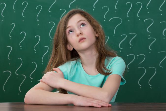 Girl With Question Marks On Chalkboard