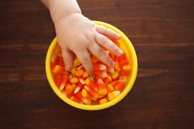 Toddler grabbing candy corn
