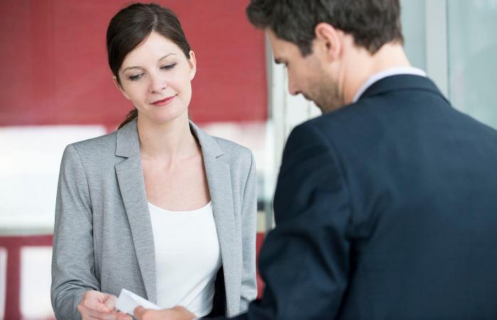 Woman handing a receipt to client