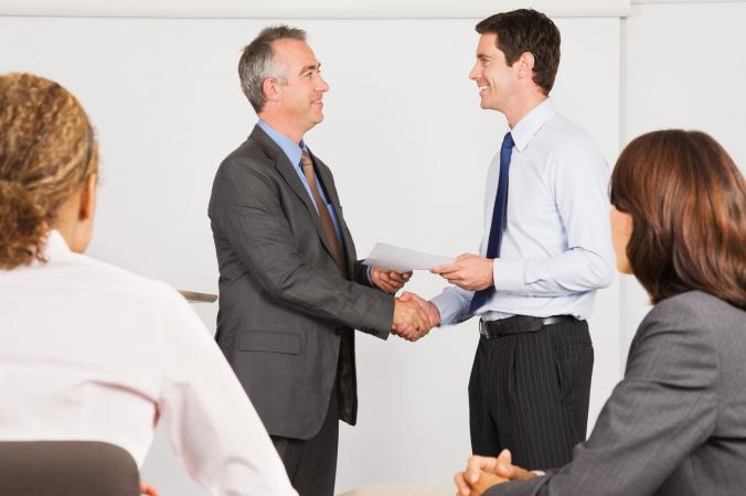 Businessman giving gift certificate to employee