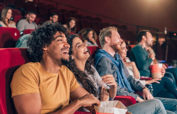 Friends laughing at cinema