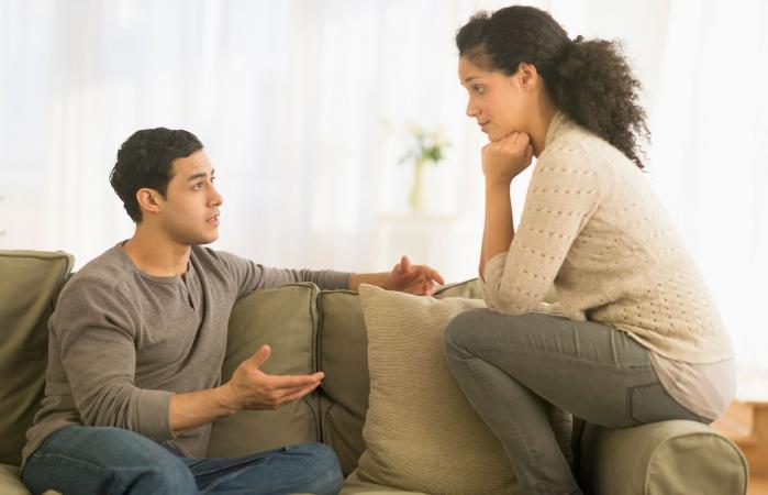 Pareja hablando en el sofá