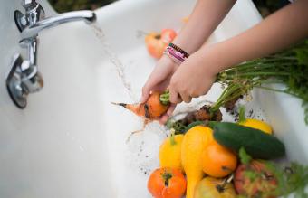 Washing vegetables under a tap