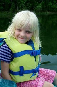 Young girl on boat wearing lifejacket