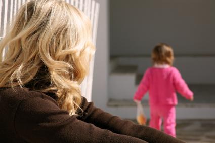 Toddler walking away from mom.