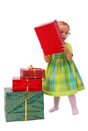A toddler checks holiday gifts.