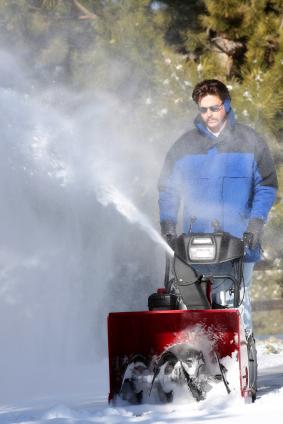 man using snow blower