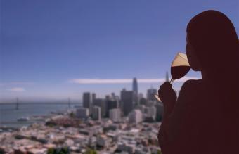 Woman with glass of wine on San Francisco city