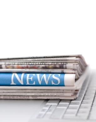 Copies of the San Francisco Chronicle on a laptop keyboard