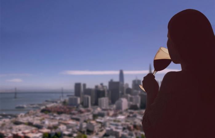 Woman with glass of wine on San Francisco city