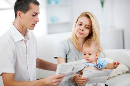 unhappy couple looking at bills