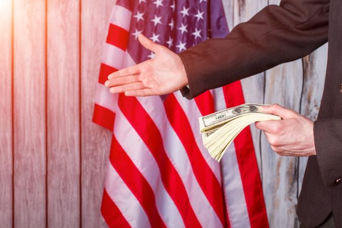 Businessman with money giving hand