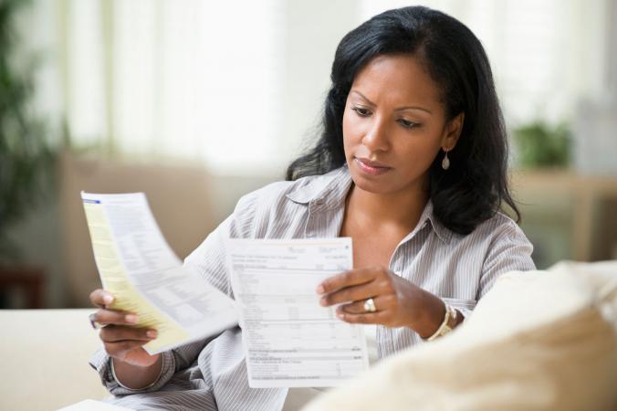 Woman reviewing cell phone bill