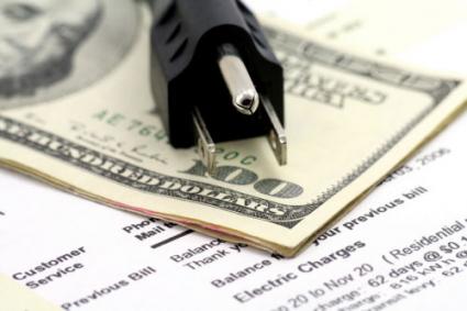 Power plug and money laying on electric bill