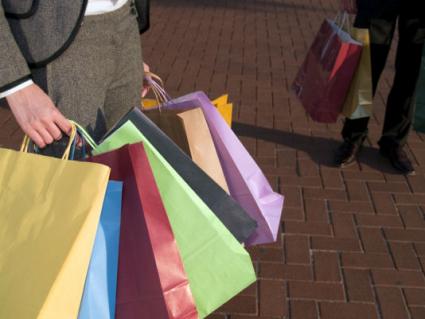 People carrying lots of shopping bags