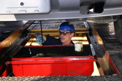 Auto technician performing an oil change