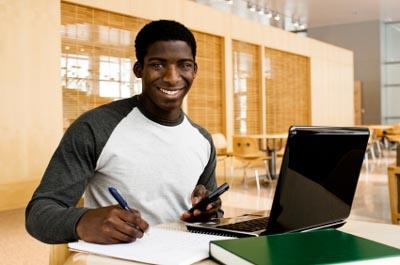 African American student with laptop and calculator