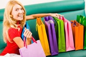 Female shopper with gift bags and purchases