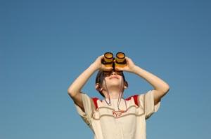 Young boy on vacation and using binoculars