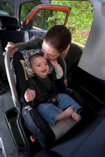 Woman fastening child into carseat