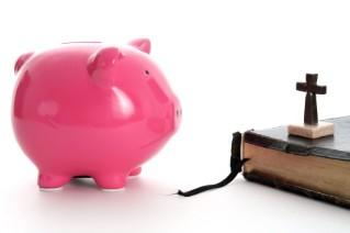 piggy bank and Bible with cross
