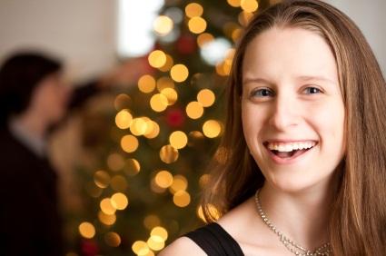 woman in front of Christmas tree