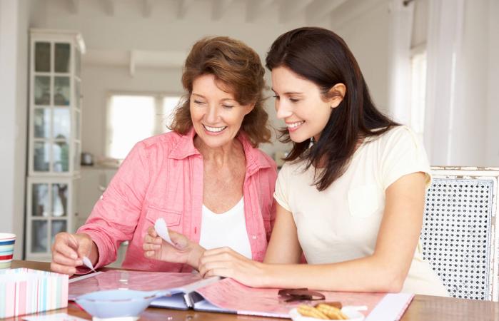 Mother and adult daughter scrapbooking