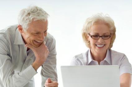 retired couple looking at digital scrapbook