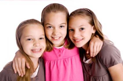 Three sisters are smiling.
