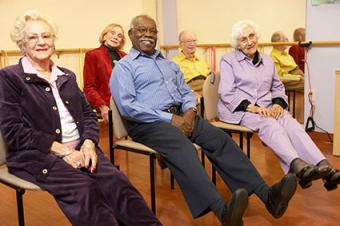 Seniors in group stretching class