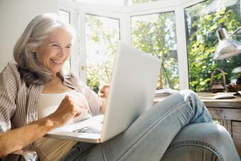 Senior woman using chatroom on computer