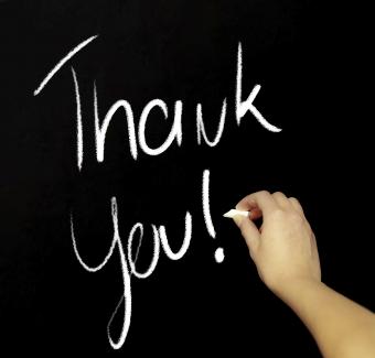 Hand writing thank you with chalk in black board