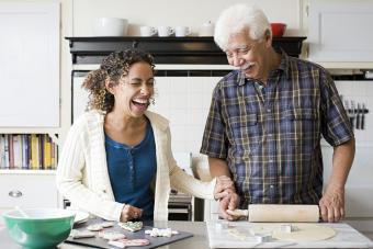 Woman baking cookies with her older dad