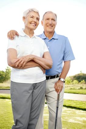Happy retired couple golfing