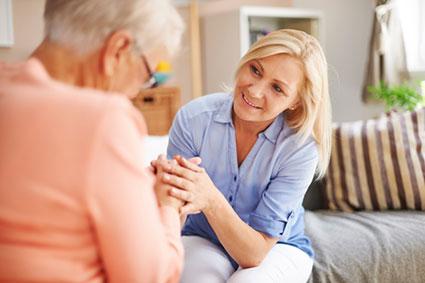 Woman talking to senior