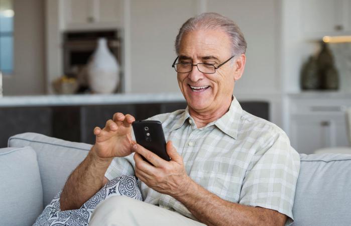 Senior man texting on cell phone