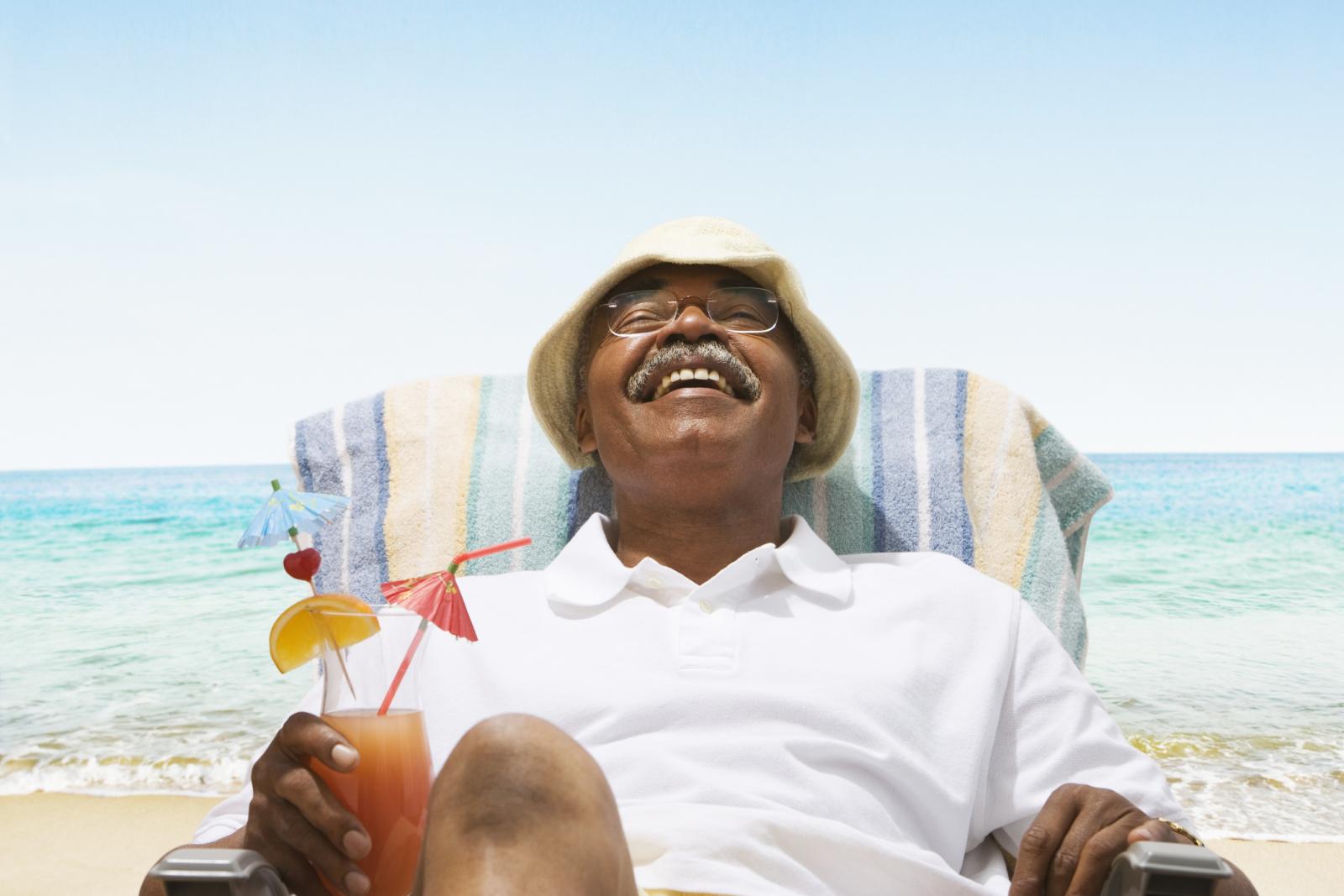 African American senior man relaxing at the beach
