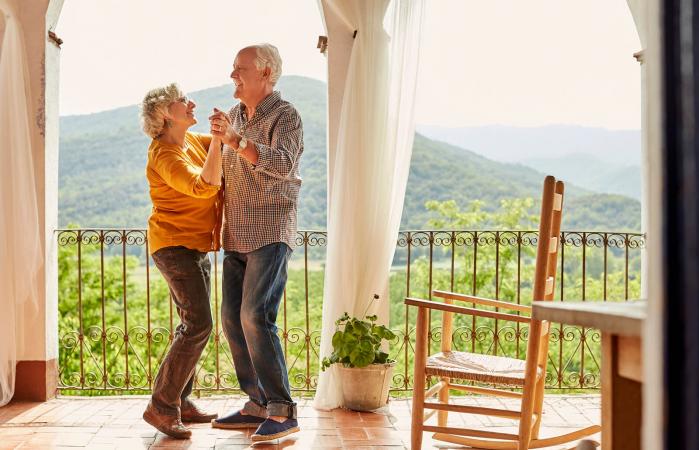 Senior couple dancing in balcony at home