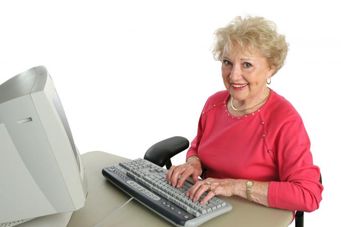 Senior woman typing on keyboard