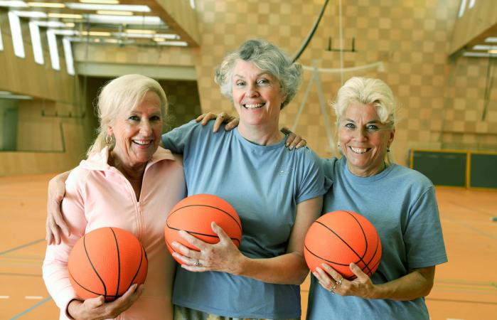Senior women holding basketballs