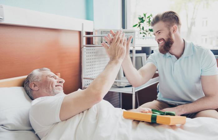 Young adult giving care package to senior
